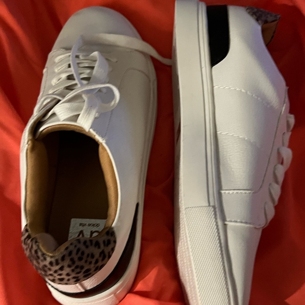 White tennis shoes with leopard print on the back